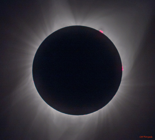 Totality with Corona highlighted. Traces of prominences can be seen from about 8 O'clock to  4 O'clock. - in addition to  large prominences at 1 and 3 O'clock.